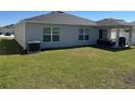 Spacious backyard featuring green grass, covered patio and home's exterior at 3166 Sweet Acres Pl, St Cloud, FL 34772