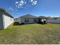 Spacious backyard featuring green grass, covered patio and home's exterior at 3166 Sweet Acres Pl, St Cloud, FL 34772