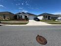 Charming single story home with a well-manicured lawn, driveway and dark blue shutters at 3166 Sweet Acres Pl, St Cloud, FL 34772
