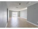 Spacious living room features tile flooring and a sliding glass door leading to a private balcony at 4205 S Semoran Blvd # 3, Orlando, FL 32822