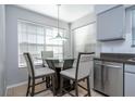 Cozy breakfast nook featuring a glass table, seating for four, and natural light from large windows at 5258 Tunbridge Wells Ln # 1902, Orlando, FL 32812