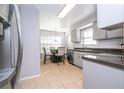 Bright eat-in kitchen featuring stainless steel appliances, granite countertops, and neutral tile flooring at 5258 Tunbridge Wells Ln # 1902, Orlando, FL 32812