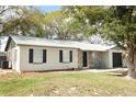 Cozy home featuring a blend of textures, a well-kept lawn, and newer roof at 558 Tyler Ave, Deltona, FL 32725