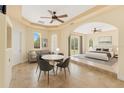 Bright bedroom with sitting area and elegant furnishings, seamlessly connected by an arched doorway at 6005 Bancroft Blvd, Orlando, FL 32833
