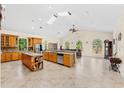 Spacious kitchen with wood cabinetry, large island, and granite countertops at 6005 Bancroft Blvd, Orlando, FL 32833