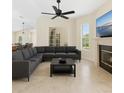 Spacious living room featuring a modern sectional sofa, fireplace, and large windows for natural light at 6005 Bancroft Blvd, Orlando, FL 32833