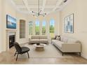 Bright living room featuring tray ceilings, large windows, and modern decor at 6005 Bancroft Blvd, Orlando, FL 32833