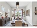 Elegant dining room featuring a decorative light fixture, a dining table, and stylish wall art at 6117 Sandy Springs Ct, St Cloud, FL 34771