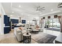 Bright living room with blue kitchen, an open floor plan, and sliding doors to the outdoor area at 6117 Sandy Springs Ct, St Cloud, FL 34771