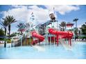 Playful waterpark featuring colorful slides, climbing nets, and a splash bucket at 7807 Loxahatchee Ct, Reunion, FL 34747