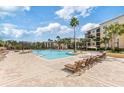 Resort-style pool with plenty of lounge seating and palm trees, perfect for relaxation at 8763 Worldquest Blvd # 5306, Orlando, FL 32821