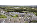 Serene aerial view of a neighborhood with a tranquil pond, lush greenery, and well-maintained homes at 889 Terrapin Dr, Debary, FL 32713