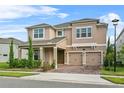 Attractive two-story home with a two-car garage, manicured shrubs, and covered entry at 889 Terrapin Dr, Debary, FL 32713