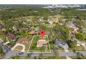 Drone view highlighting this residential home's location in a neighborhood surrounded by lush trees at 109 Sweetwater Oaks Ln, Daytona Beach, FL 32114