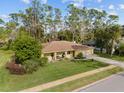 Landscaped front yard with mature trees framing this well-kept single-Gathering home at 109 Sweetwater Oaks Ln, Daytona Beach, FL 32114