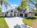 Beautiful new construction featuring a spacious three-car garage and modern architectural design at 1475 Warrior Trl, Enterprise, FL 32725
