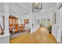 Elegant dining room with hardwood floors and decoratively appointed furniture adjacent to the living area at 1741 Pine Ave, Winter Park, FL 32789