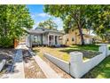 Charming home with inviting front porch, manicured lawn, and walkway leading to the entrance at 1900 Garvin St, Orlando, FL 32803
