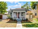 Charming home with inviting front porch, manicured lawn, and walkway leading to the entrance at 1900 Garvin St, Orlando, FL 32803