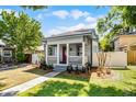 Charming home with inviting front porch, manicured lawn, and walkway leading to the entrance at 1900 Garvin St, Orlando, FL 32803