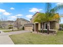 Attractive home with two-car garage, brick driveway, stone accents, and a well-maintained lawn at 2371 Victoria Dr, Davenport, FL 33837