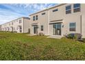 Backyard featuring a well-maintained lawn and sliding glass doors at 2788 Pierr St, Davenport, FL 33837