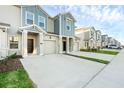 Attractive street view showcasing well-maintained townhomes with driveways and manicured landscaping at 2788 Pierr St, Davenport, FL 33837