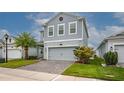 Charming two-story home with a brick paver driveway and well-maintained landscaping at 3010 Ballad Rd, Kissimmee, FL 34746