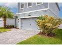 Garage and front yard of a charming home with well-maintained landscaping at 3010 Ballad Rd, Kissimmee, FL 34746