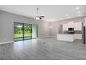 Bright and airy living area with access to the outdoors and a modern kitchen at 30340 W Bluebell Ave, Eustis, FL 32736
