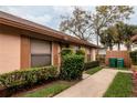 Lovely home exterior highlighting mature trees, green bins, and a walkway at 358 Douglas Way # 78, Winter Garden, FL 34787