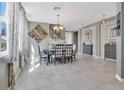 Inviting dining room with elegant lighting and tile floors, ideal for Gathering gatherings at 4107 Briar Gate Ln, Winter Garden, FL 34787