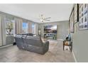 Comfortable living room with tile floors, a ceiling fan, and a large television at 4107 Briar Gate Ln, Winter Garden, FL 34787