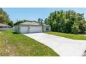 Attractive single-story home with a generous driveway leading to a two-car garage, surrounded by green lawns at 4198 Sw 128Th Pl, Ocala, FL 34473