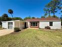 A single story home with an attached carport and a well-manicured lawn at 472 Rosalia Dr, Sanford, FL 32771