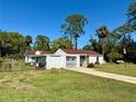 A single story home with an attached carport and a well-manicured lawn at 472 Rosalia Dr, Sanford, FL 32771