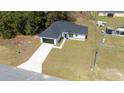 Aerial view showcasing a home with a long driveway and large front lawn at 4914 Sw 147Th Loop, Ocala, FL 34473