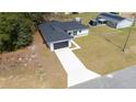 Aerial view showcasing a home with a long driveway and large front lawn at 4914 Sw 147Th Loop, Ocala, FL 34473