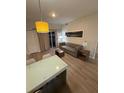 Bright living room featuring modern furnishings, stylish lighting, comfortable seating, and natural light at 7395 Universal Blvd # 104, Orlando, FL 32819