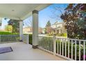 Inviting covered front porch with white railings, providing a charming outdoor space to relax at 8321 Bryce Canyon Ave, Windermere, FL 34786