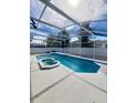 Relax in this stunning screened-in swimming pool and spa at 8630 Knottingham Dr, Kissimmee, FL 34747