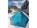 Enjoy the outdoors with this stunning screened-in swimming pool and spa at 8630 Knottingham Dr, Kissimmee, FL 34747