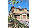 Two-story townhome with a 2-car garage, landscaped yard, and a brick driveway at 8923 Azalea Sands Ln, Davenport, FL 33896