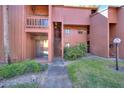 Exterior of the building with a staircase, balcony, and landscaped surroundings at 974 E Michigan St # 974, Orlando, FL 32806