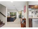 Open living room with a view from kitchen, plush sofa, and neutral color palette at 974 E Michigan St # 974, Orlando, FL 32806