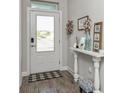 Bright foyer featuring stylish wood-look tile flooring and a decorative console table at 985 Huntspoint St, Winter Garden, FL 34787