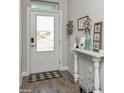 Bright foyer with stylish decor, wood-look tile flooring, and ample natural light at 985 Huntspoint St, Winter Garden, FL 34787
