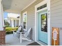 Inviting front porch with blue door and seating area at 985 Huntspoint St, Winter Garden, FL 34787