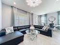 Stylish living room featuring a sleek leather sectional and modern decor at 9971 Highland Sky Aly, Orlando, FL 32832