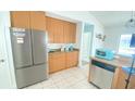 Kitchen featuring stainless steel appliances and tan cabinetry, with plenty of counter space at 1001 Lester Ridge Ct, Kissimmee, FL 34747